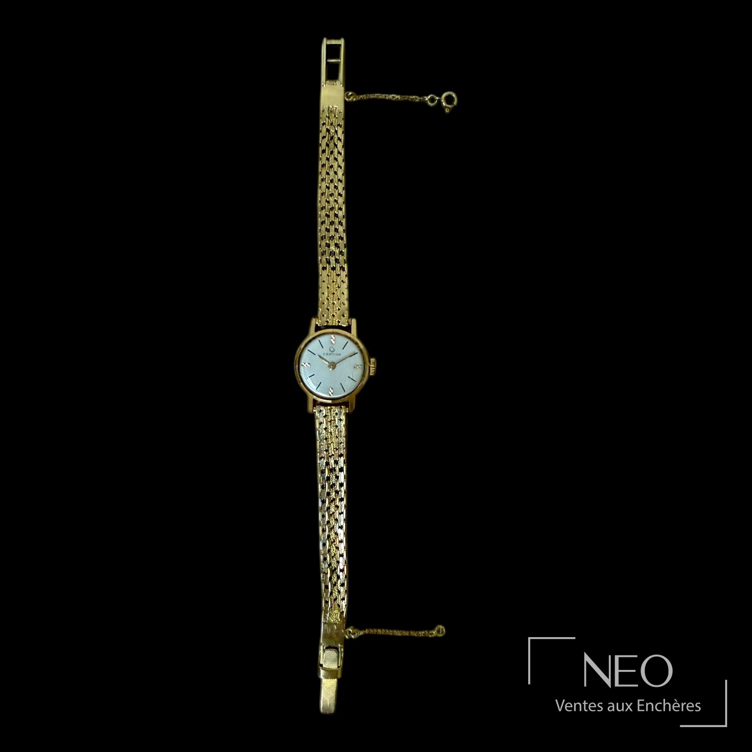 Profil de la montre en or jaune avec bracelet souple et chaînette de sécurité